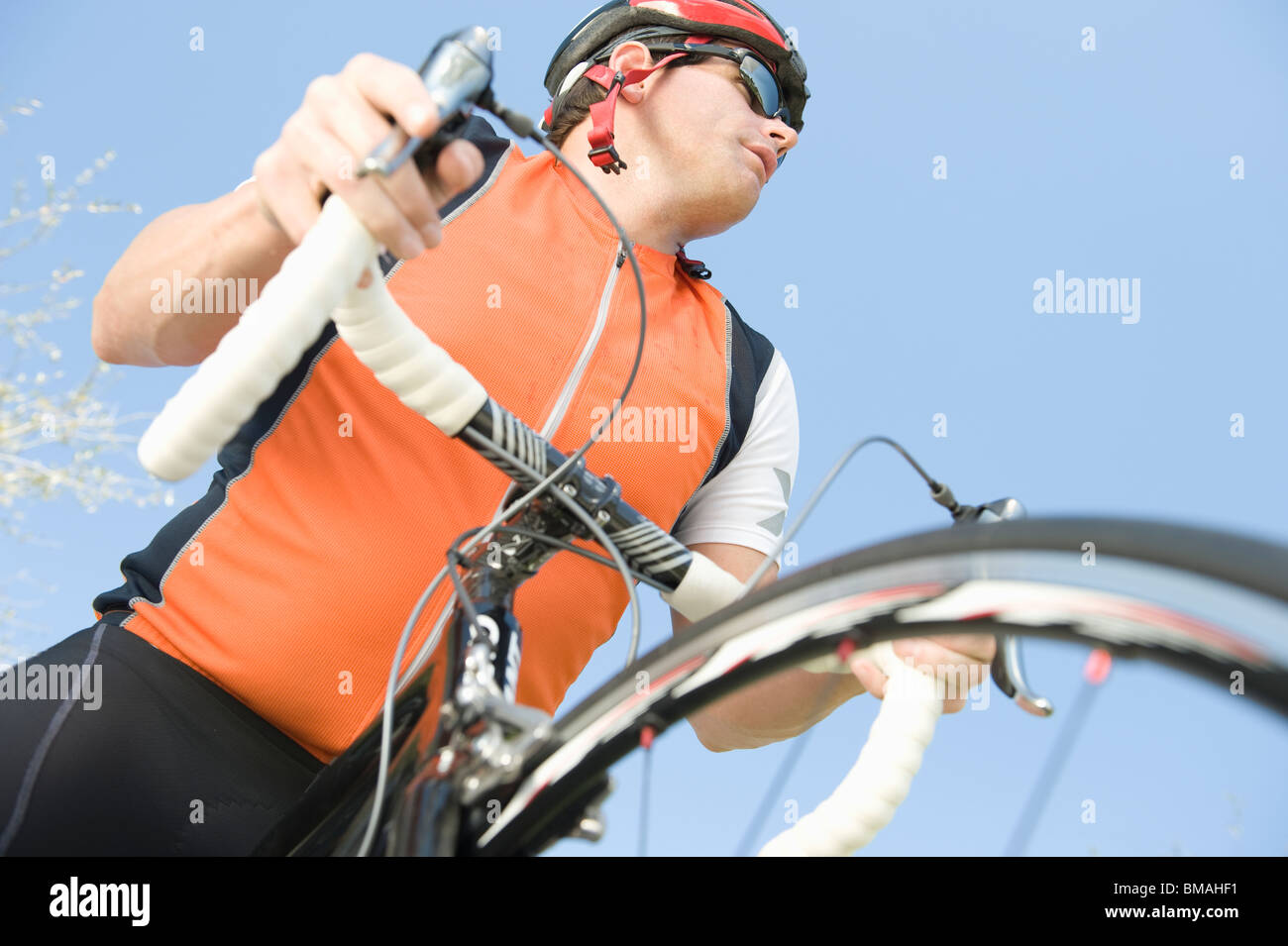 Male cyclist with metallic wheel rims Stock Photo