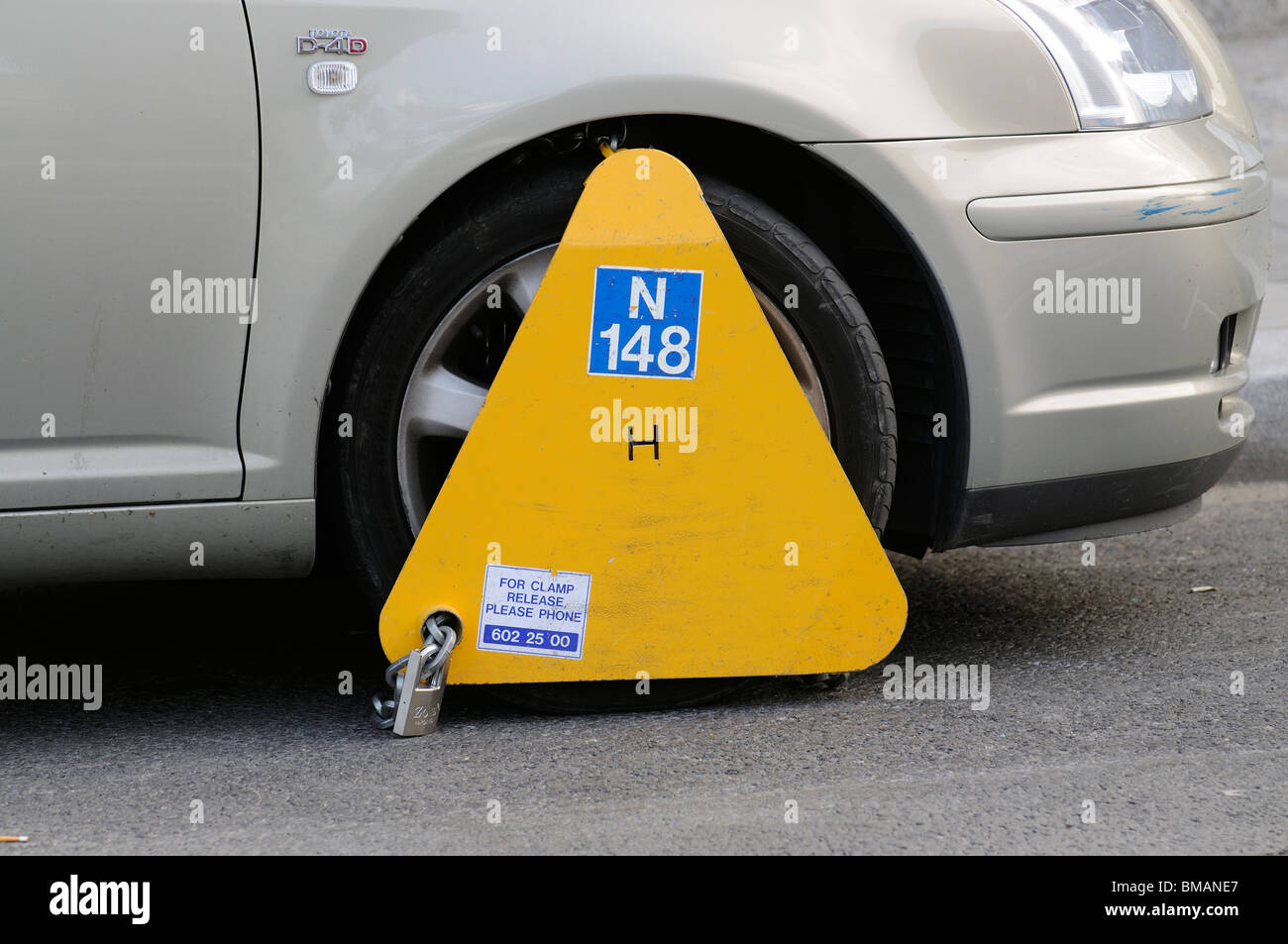 Wheel clamp in place on an illegally parked Toyota car on a Dublin