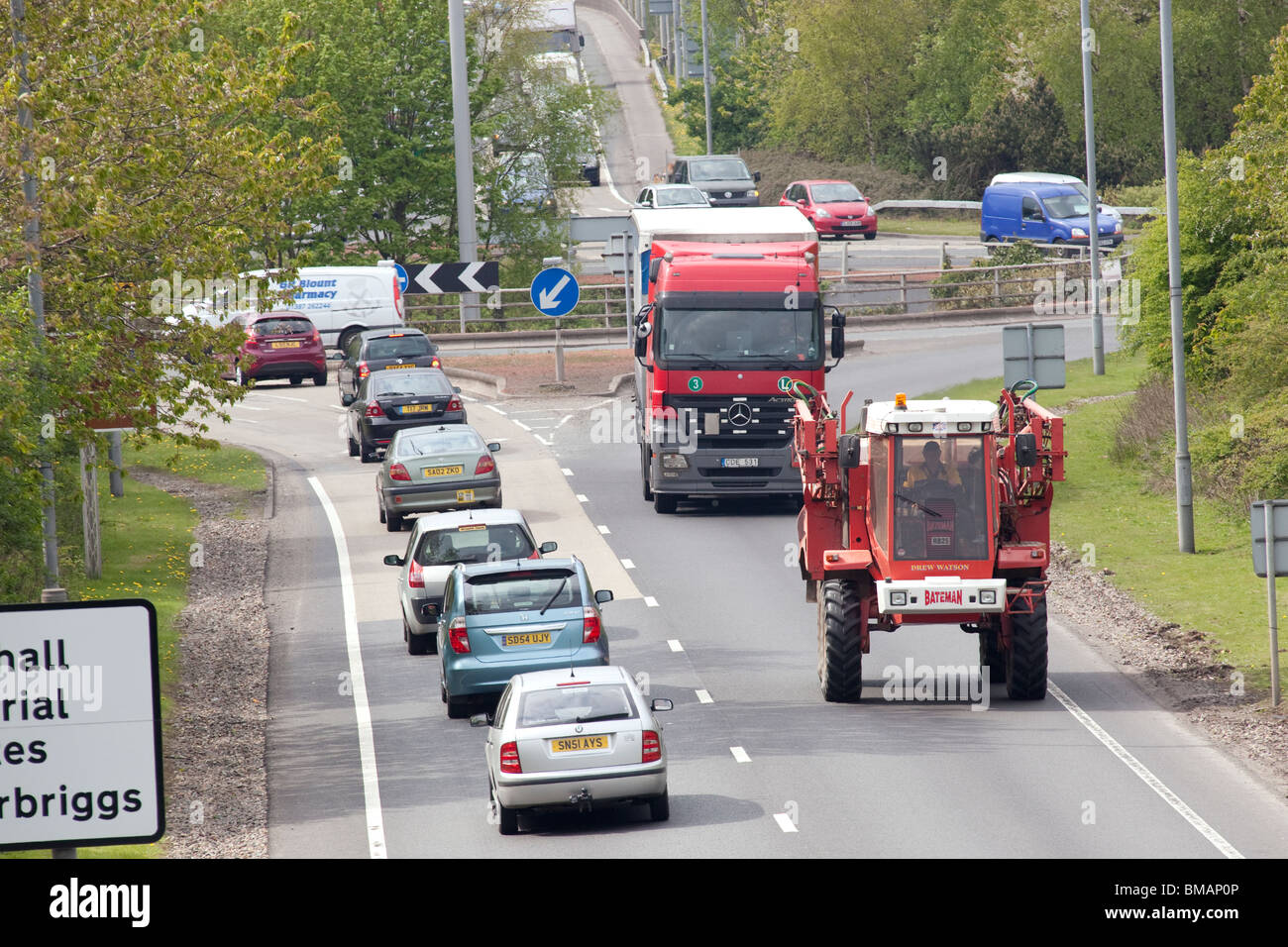 A75 road busy roundabout near Dumfries UK slow moving agricultural