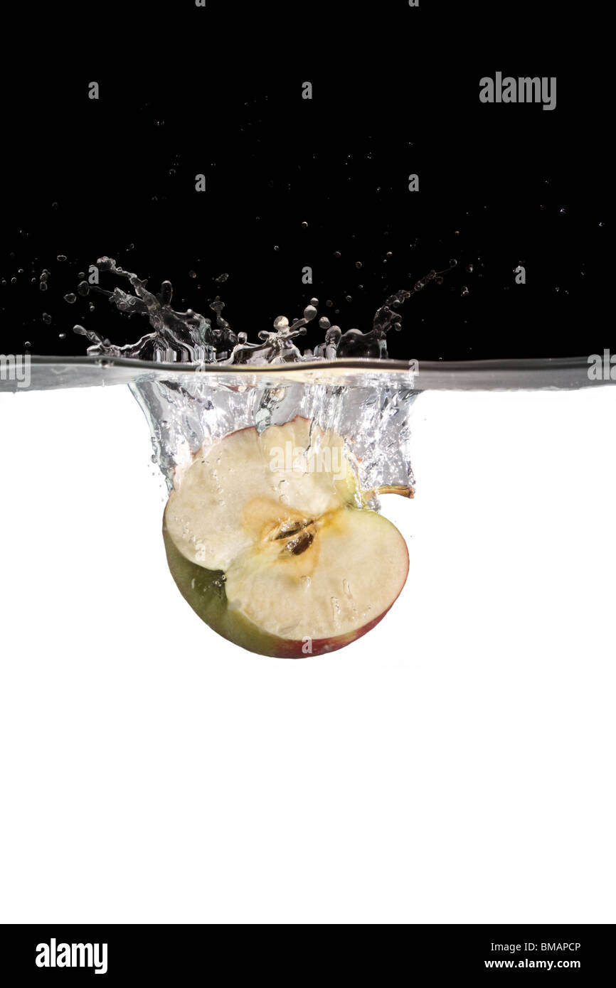 half apple thrown in water Stock Photo