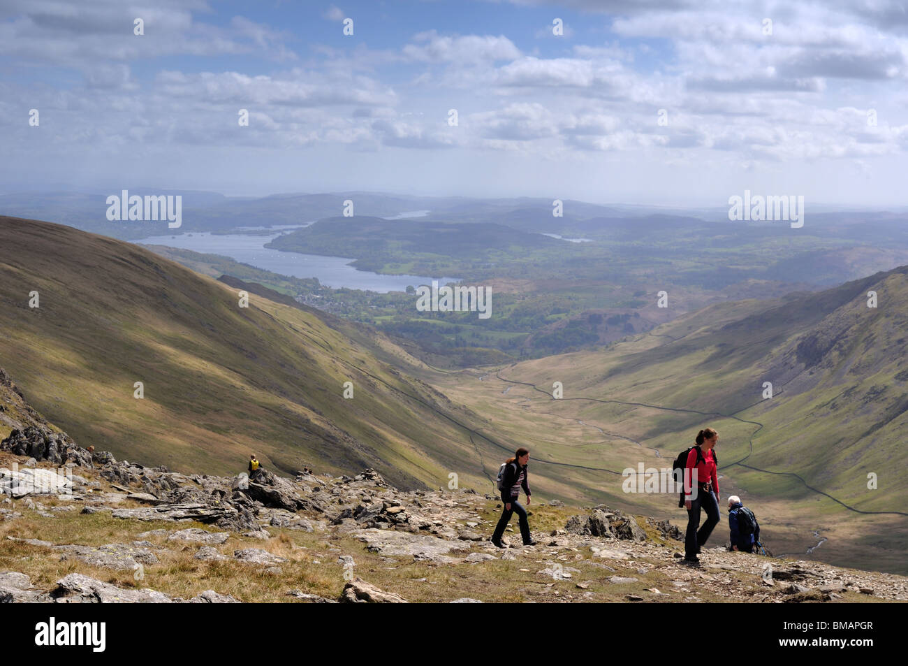 Walkers on Hart Crag in the Lake District with Ambleside and Lake