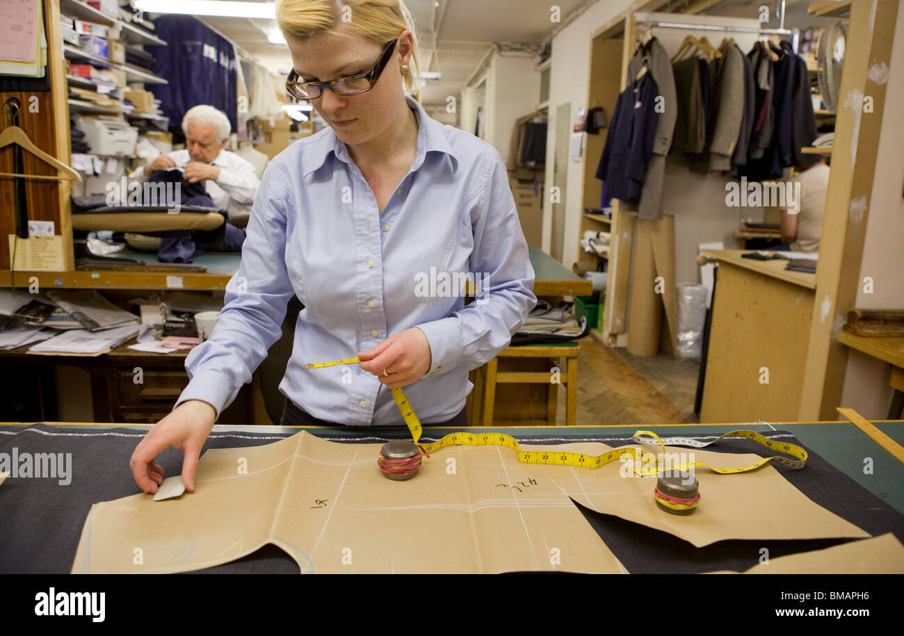 Tailors working in the workshop of Stowers Bespoke, in Savile Row, London. Stock Photo