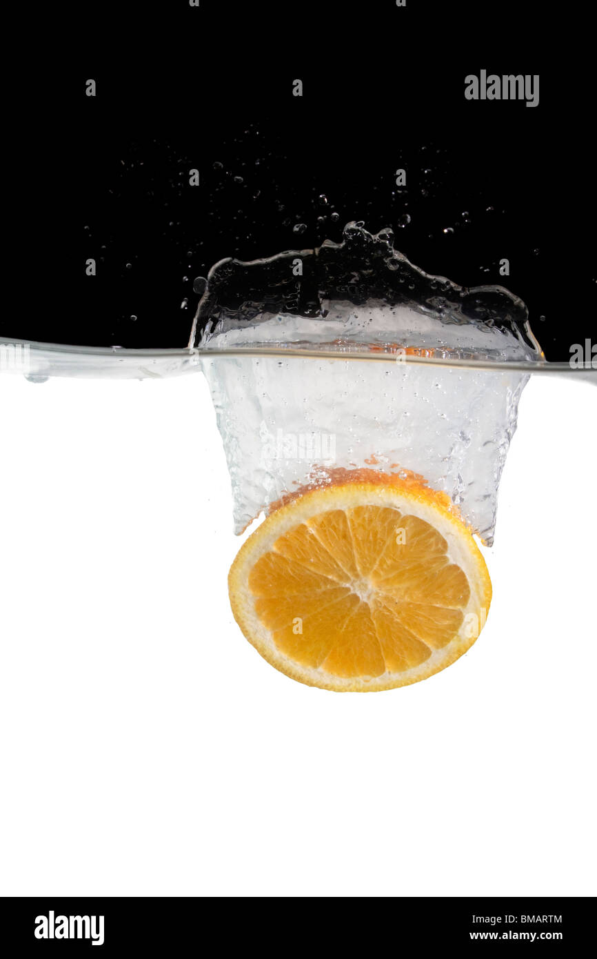 orange slice thrown in water with black and white background Stock ...