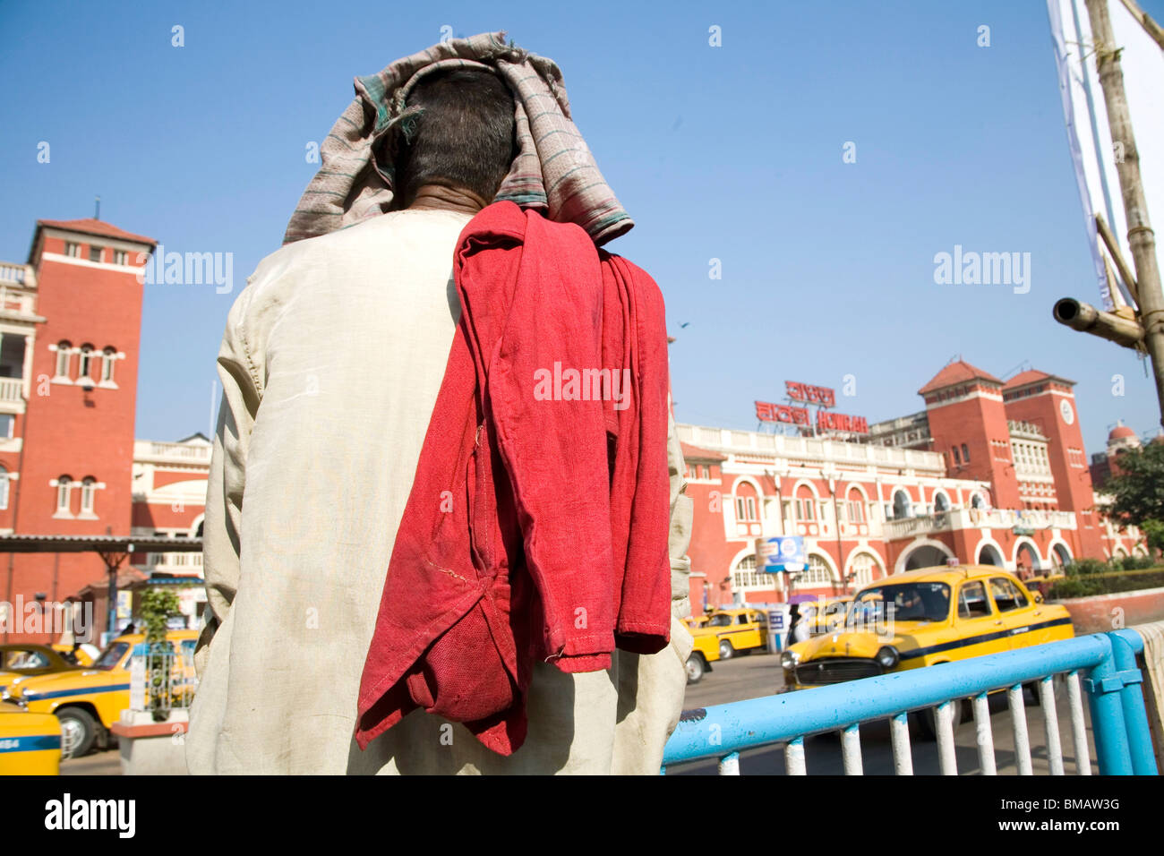 Cooli or porter wearing red color dress sitting near Howrah railway station ; Calcutta now Kolkata ; West Bengal ; India Stock Photo