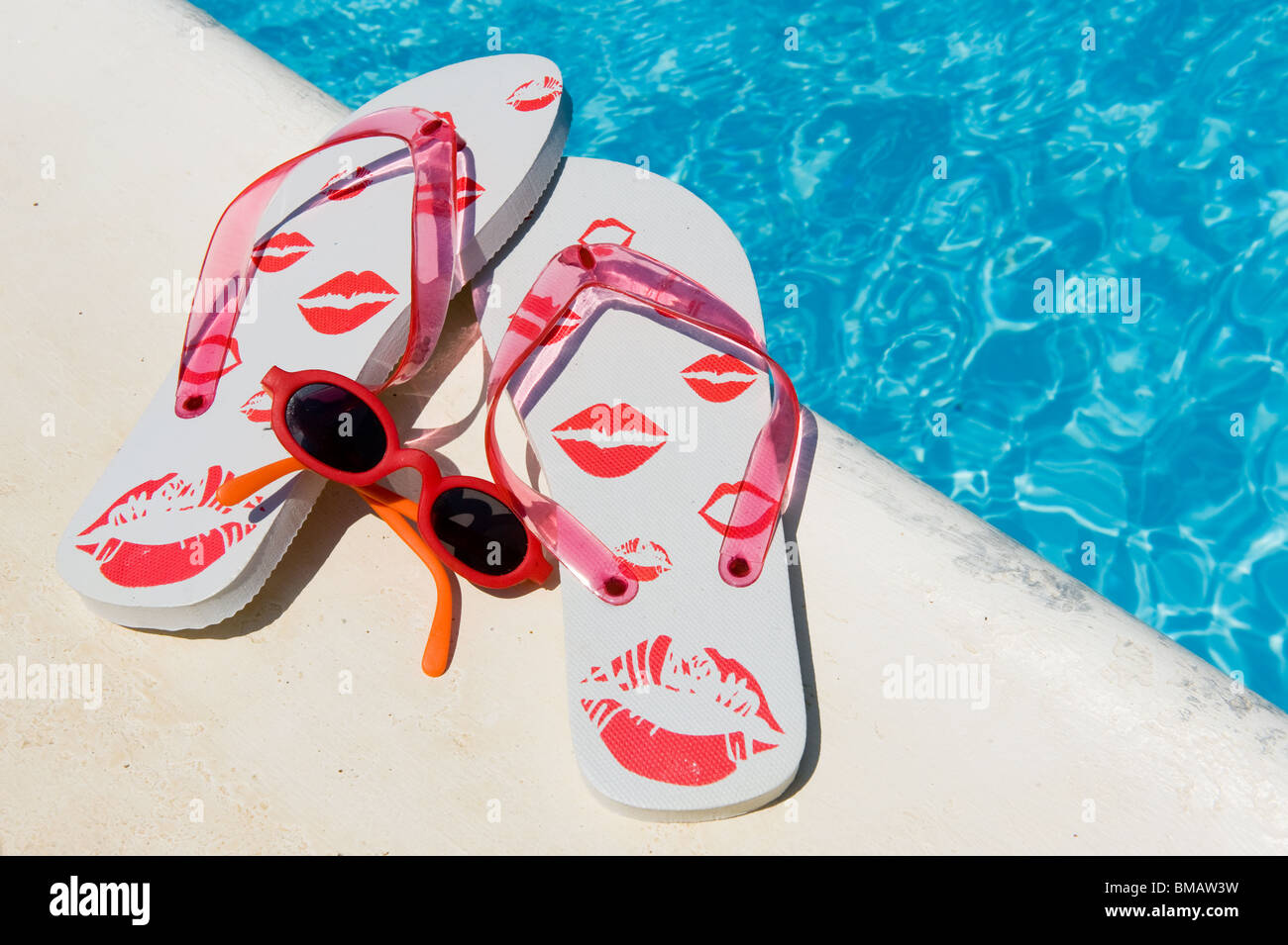 Flip flops and sunglasses near the swimming pool Stock Photo - Alamy