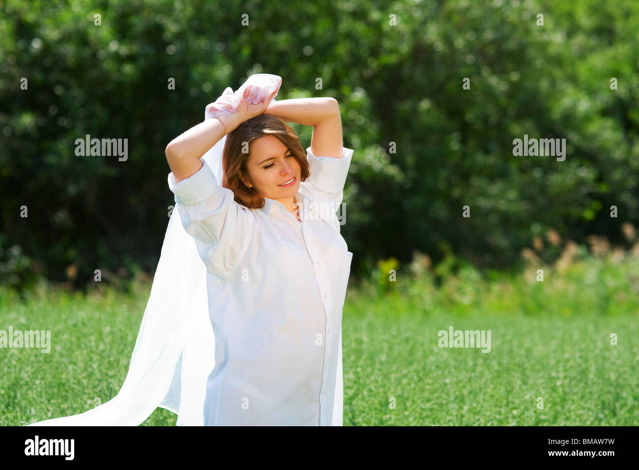 Happy young woman relaxing on nature Stock Photo - Alamy