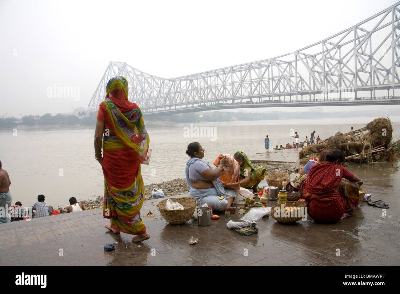 Activities on Babu ghat ; Howrah bridge over Hooghly river in background ;  Calcutta now Kolkata ; West Bengal ; India Stock Photo - Alamy, image size:1300x956