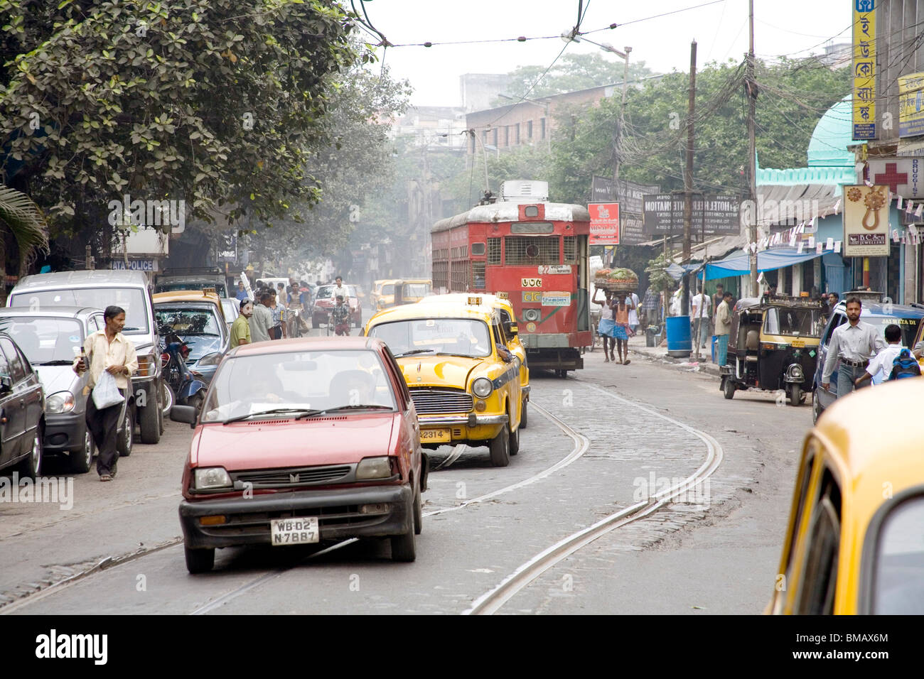 Street scene car taxi tram on road ; Calcutta now Kolkata ; West Bengal ; India Stock Photo Alamy