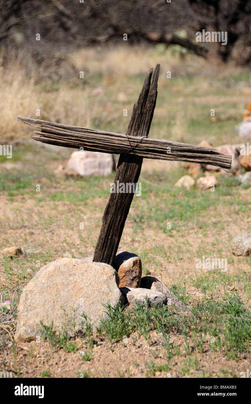 A wooden cross marks a grave in a cemetery in Helvetia, a ghost town in Pima County, Arizona