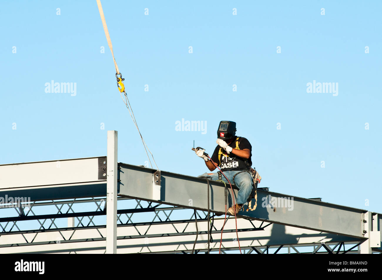 steelworker welds the structural steel framework for a commercial building Stock Photo