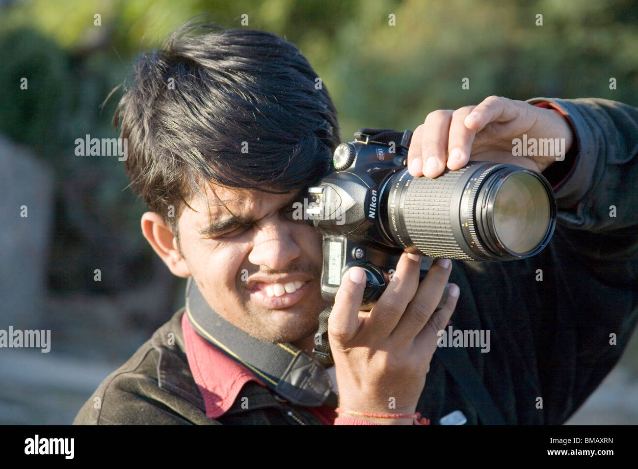 Photographer shooting with digital camera zoom lens learning photography ; Dilwara ; Udaipur ; Rajasthan ; India Stock Photo