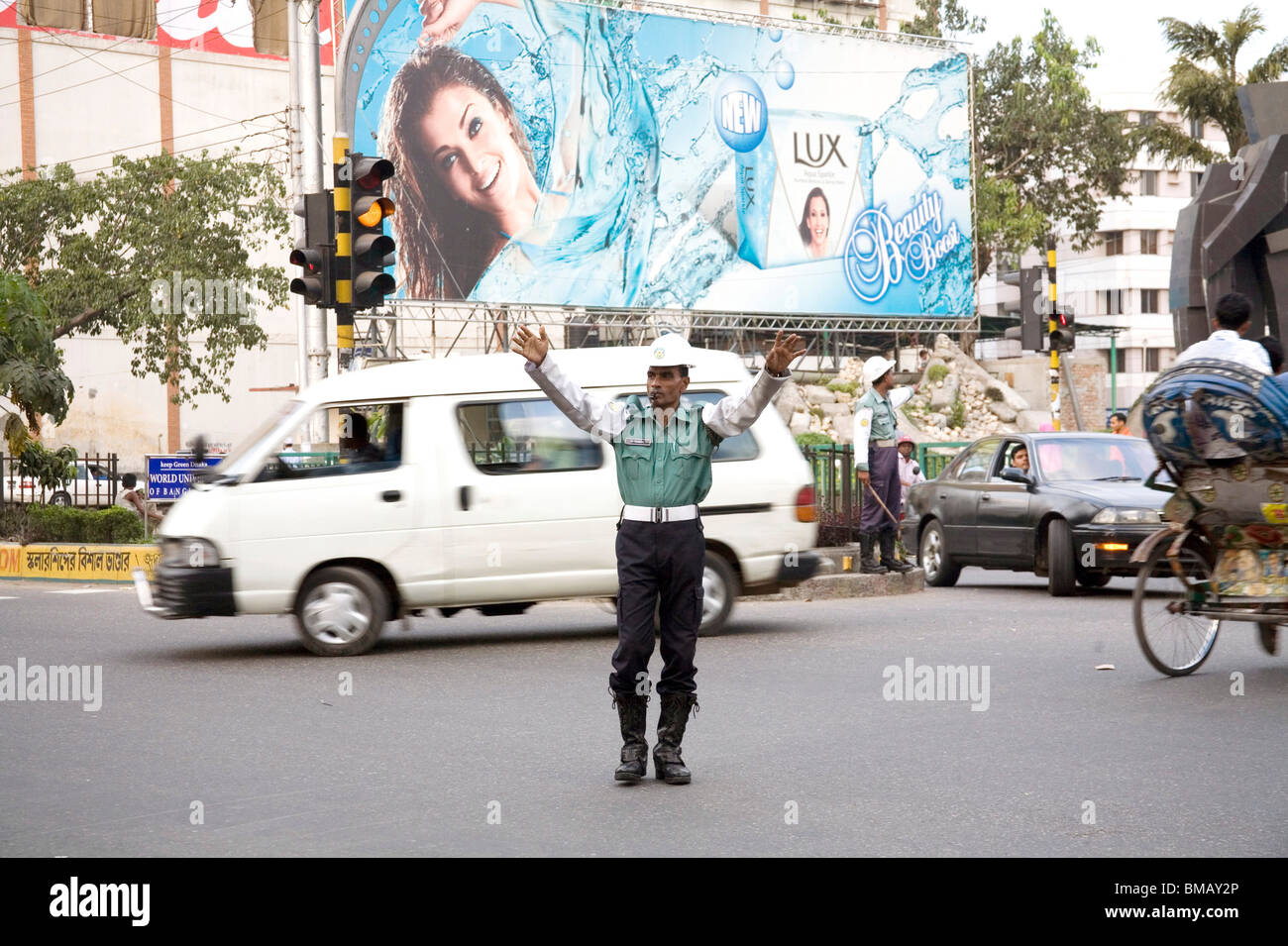 Traffic police controlling traffic on street hoarding of popular Indian film actress Ashwarya Rai ; Dhaka ; Bangladesh Stock Photo