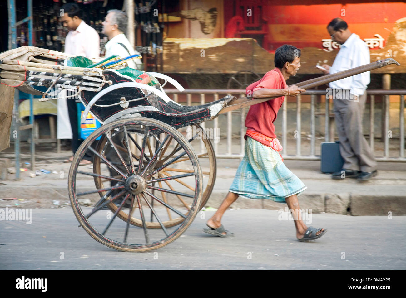 Hand pulling rickshaw puller pulling hires stock photography and
