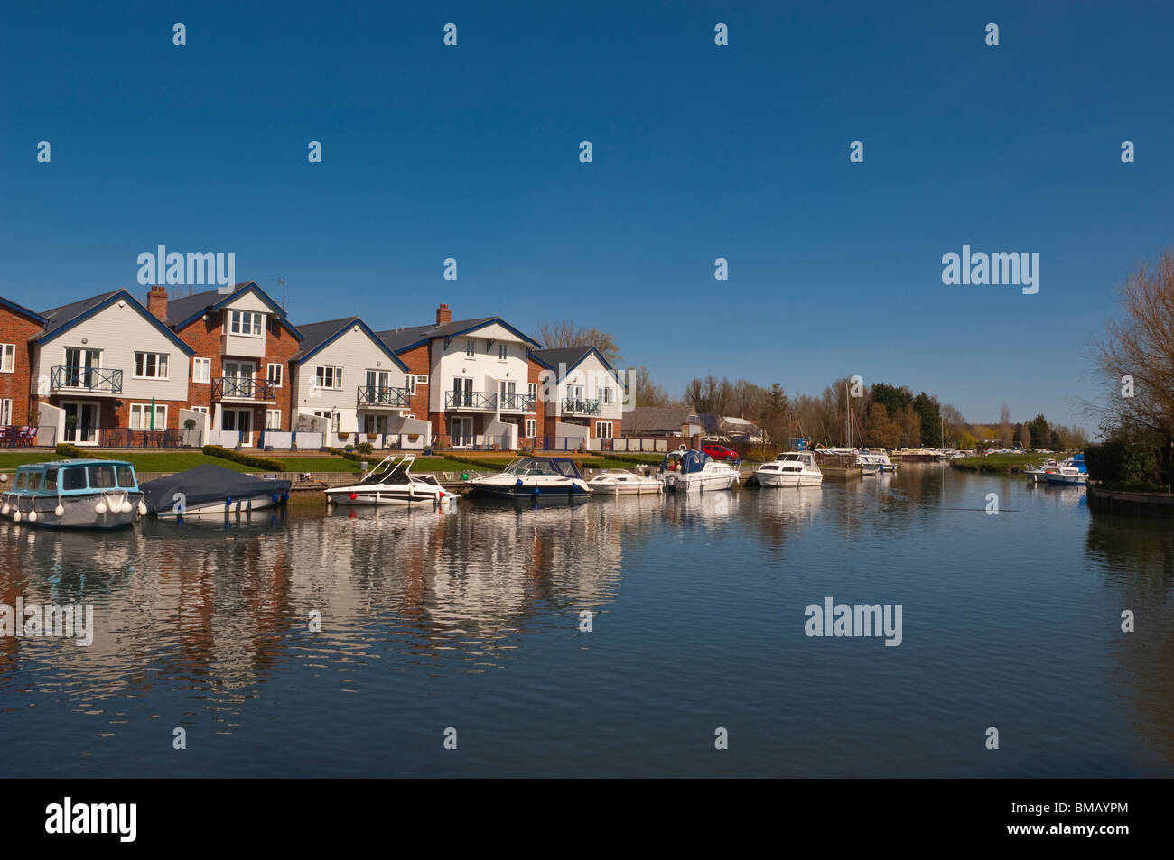 Boats and river fronted houses on the river Chet at Loddon , Norfolk