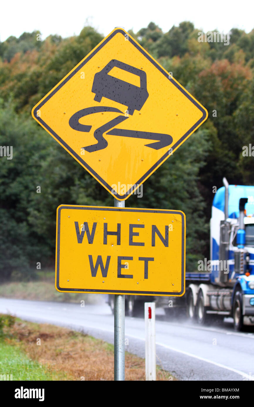 Australian yellow sign indicating slippery when wet Stock Photo