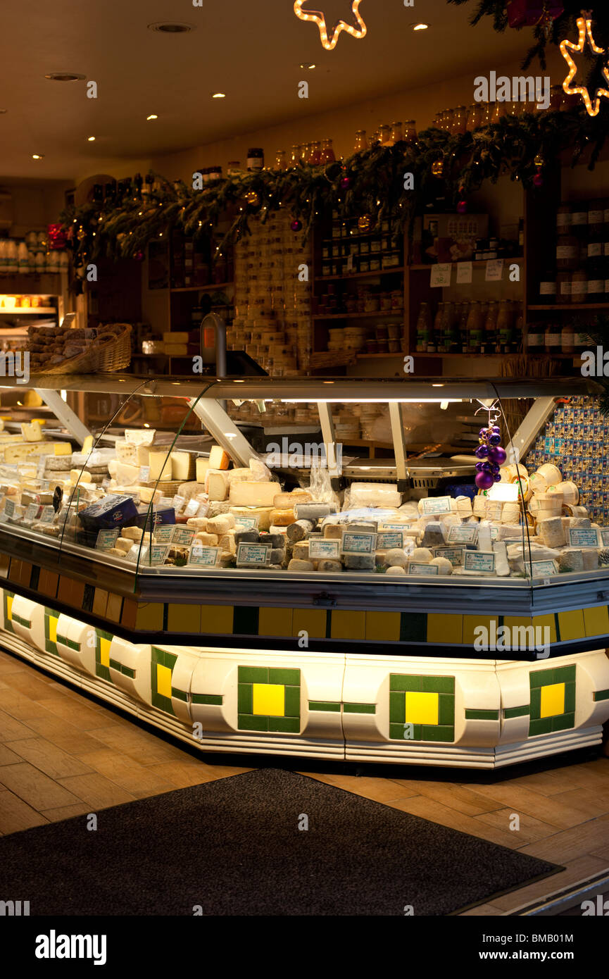The well-lit display counter of a cheese shop in Paris. Stock Photo