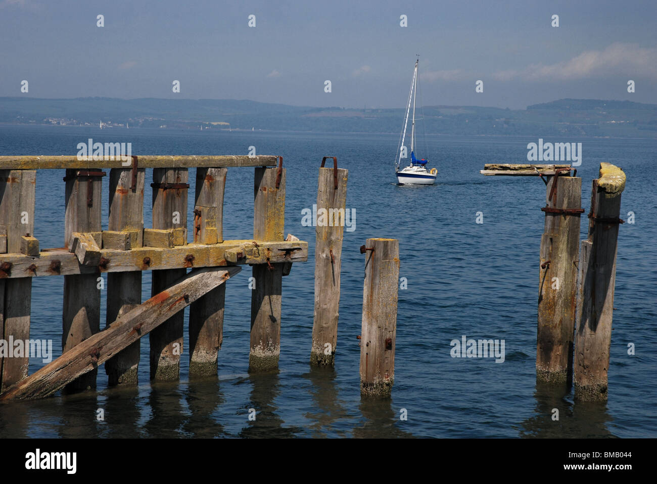 Yacht approaching the derelict pier at Granton Harbour, Edinburgh