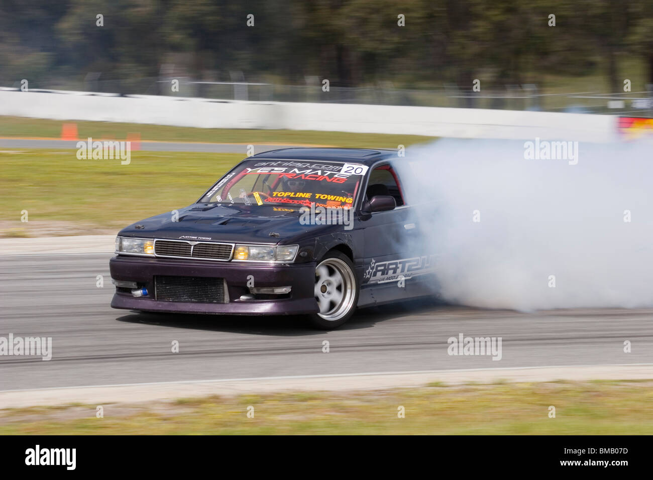 Western Australian drift racer, James Eames, sliding his highly modiified Nissan Laurel around a corner in a drift competition. Stock Photo