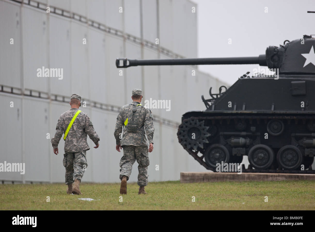 Two U.S. Army soldiers  walk past a tank on display at Fort Hood, a large military base near Killeen, Texas, USA. Stock Photo