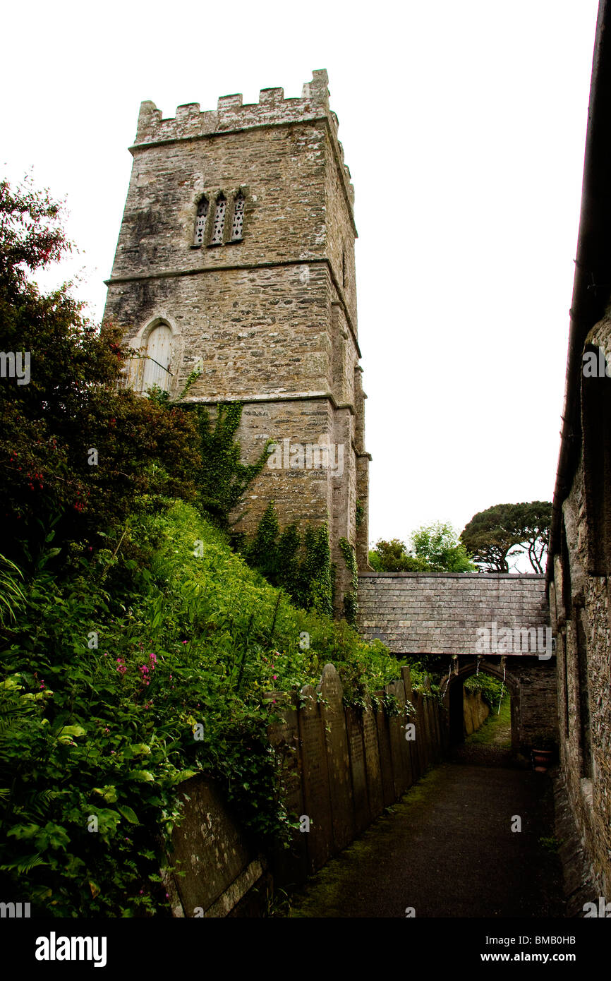 Entry path showing the tower and gravestones at Talland Parish Church near Looe in Cornwall, UK Stock Photo