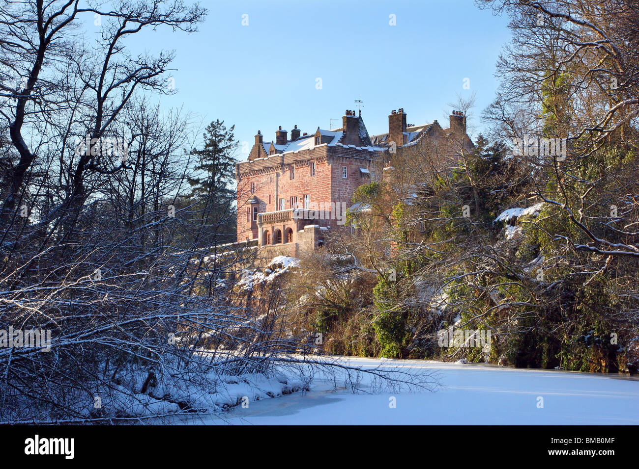 Sorn Castle with the River Ayr frozen over in winter 2010. The castle dates from the 14th Century. Stock Photo