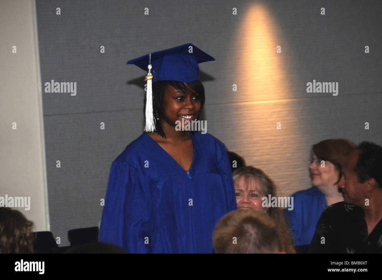 Home schooled high schooled graduate walks down to receive her diploma at a graduation ceremony in Riverdale Park, Maryland Stock Photo