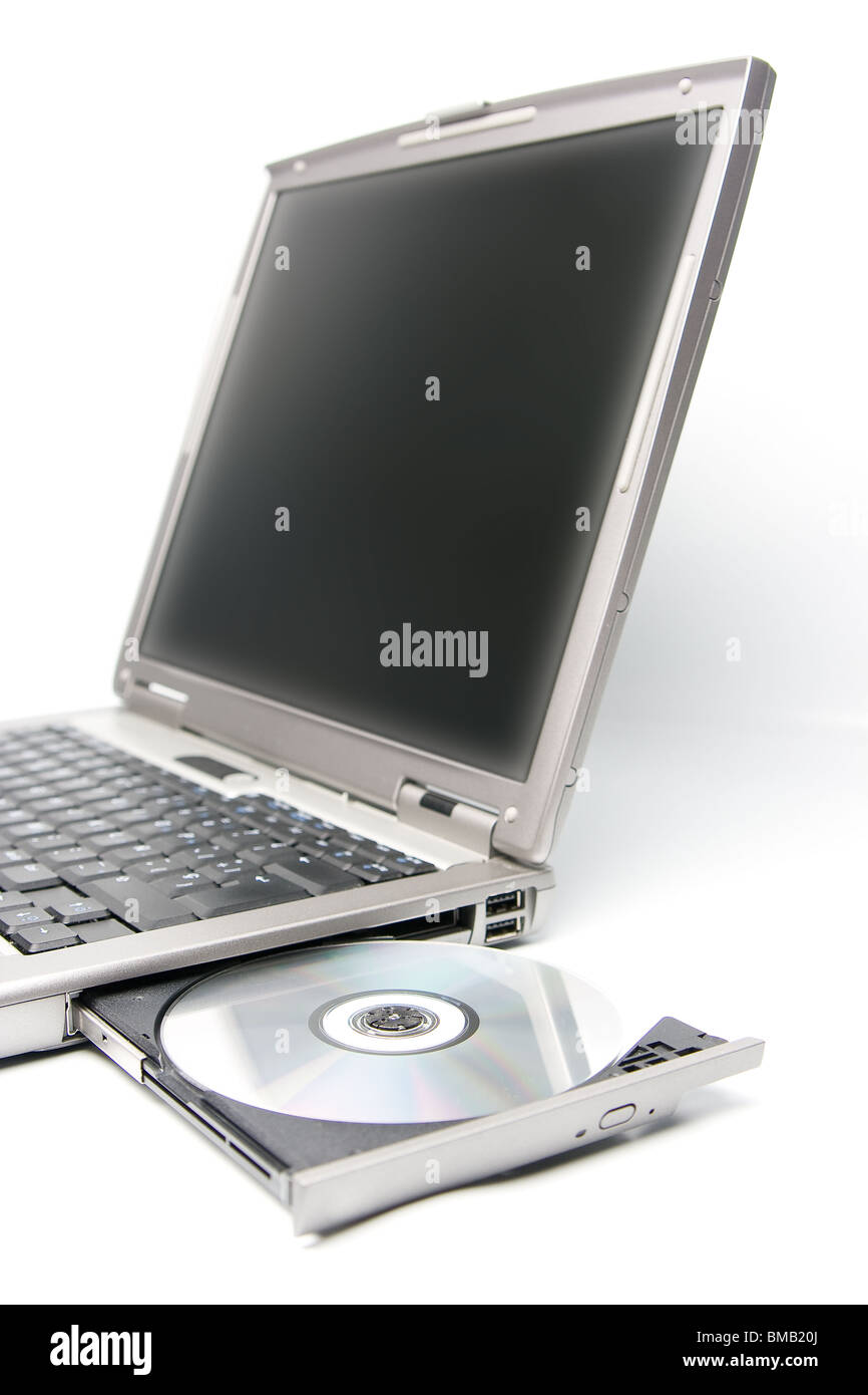 cd or dvd disk in the drive of a laptop Stock Photo