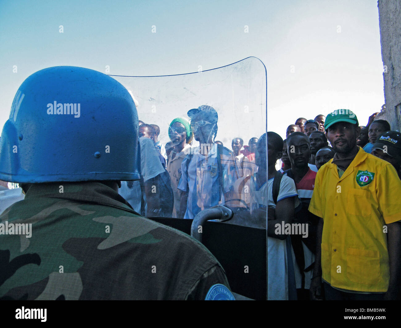 United Nations peacekeepers hold back crowds outside an aid center in