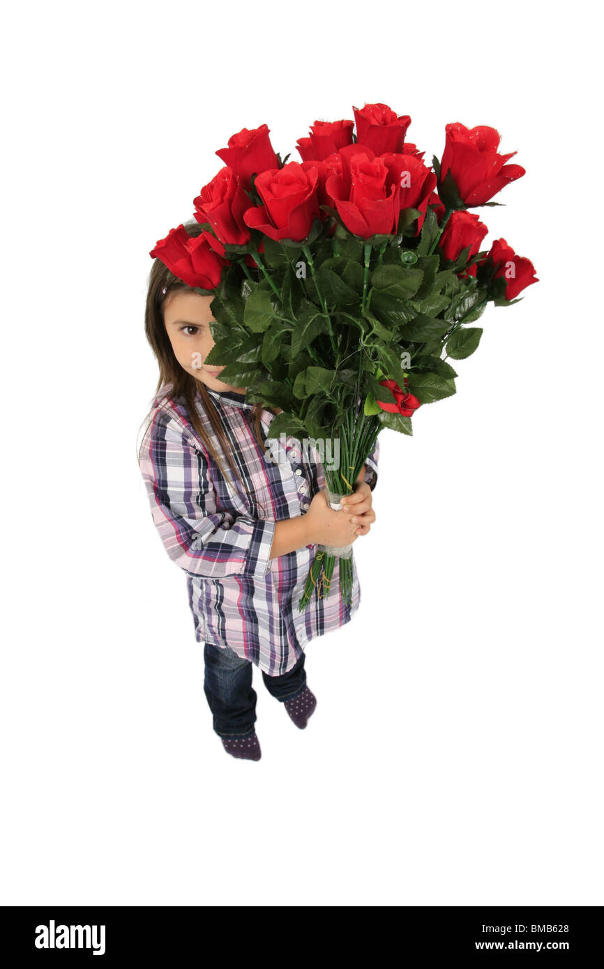 little girl hiding behind a bunch of red roses Stock Photo