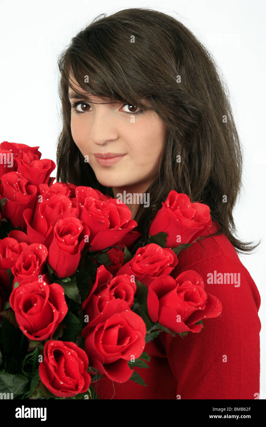 pretty young girl with a bunch of red roses Stock Photo