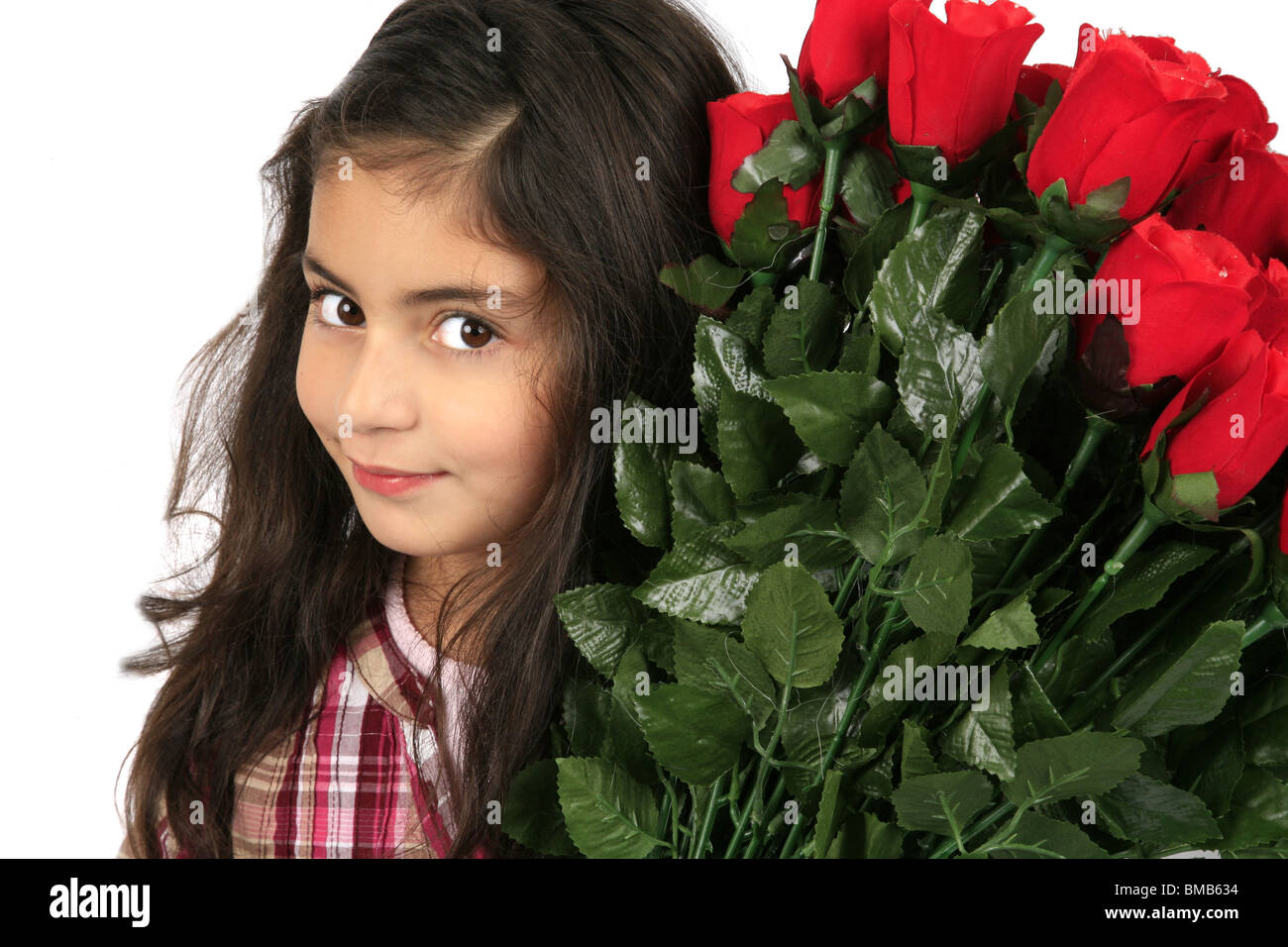 little girl with a bunch of red roses Stock Photo