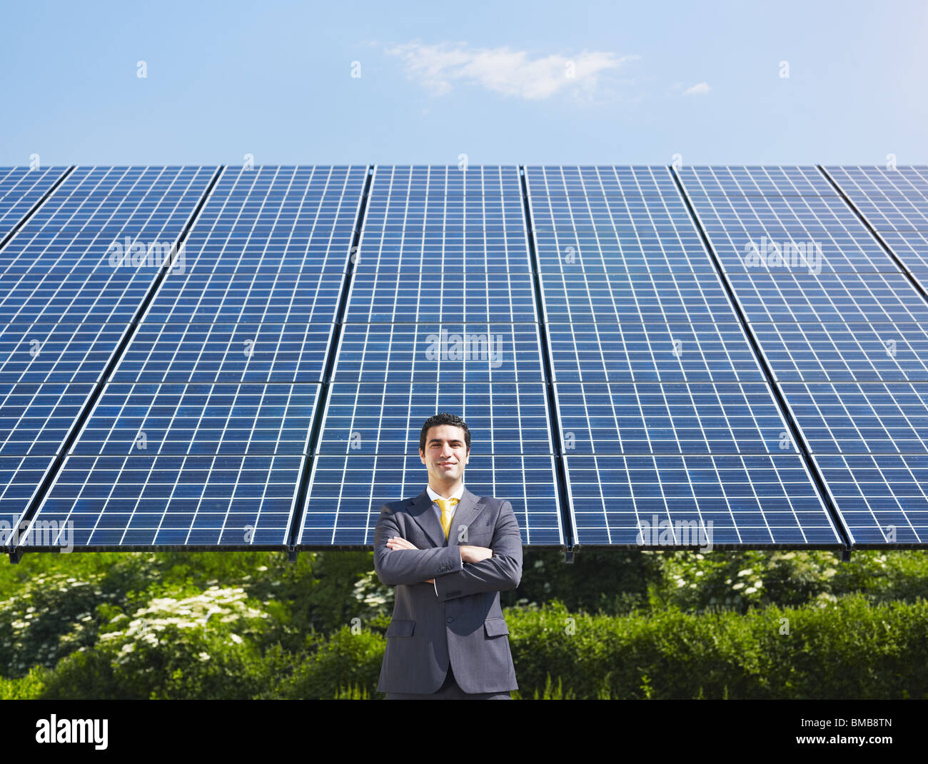 businessman standing near solar panels Stock Photo