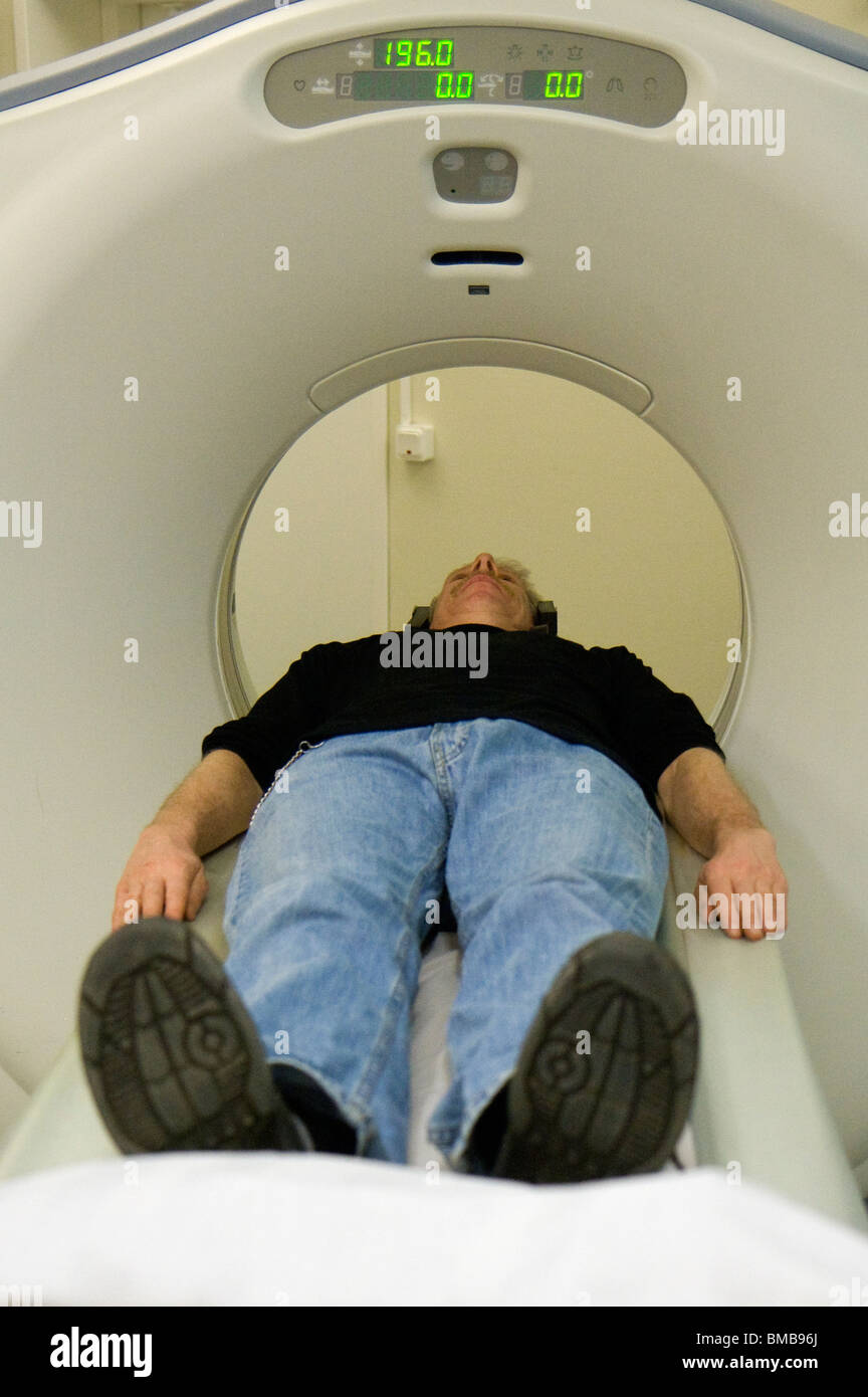 Man being adjusted to the right position before doing a CT (Computer Tomography) scan of the head. Stock Photo