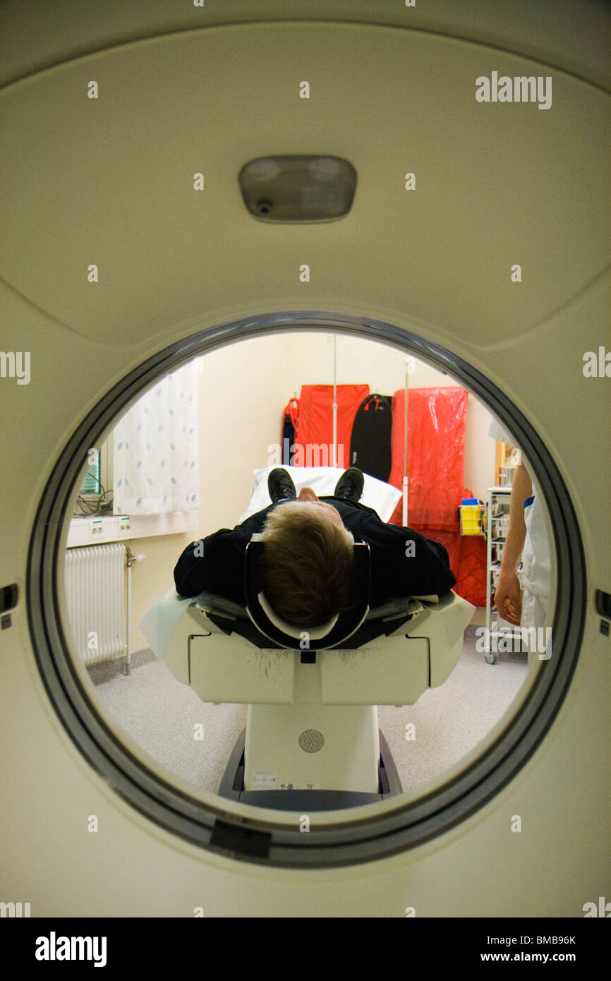 Man being going into theright position before doing a CT (Computer Tomography) scan of the head. Stock Photo