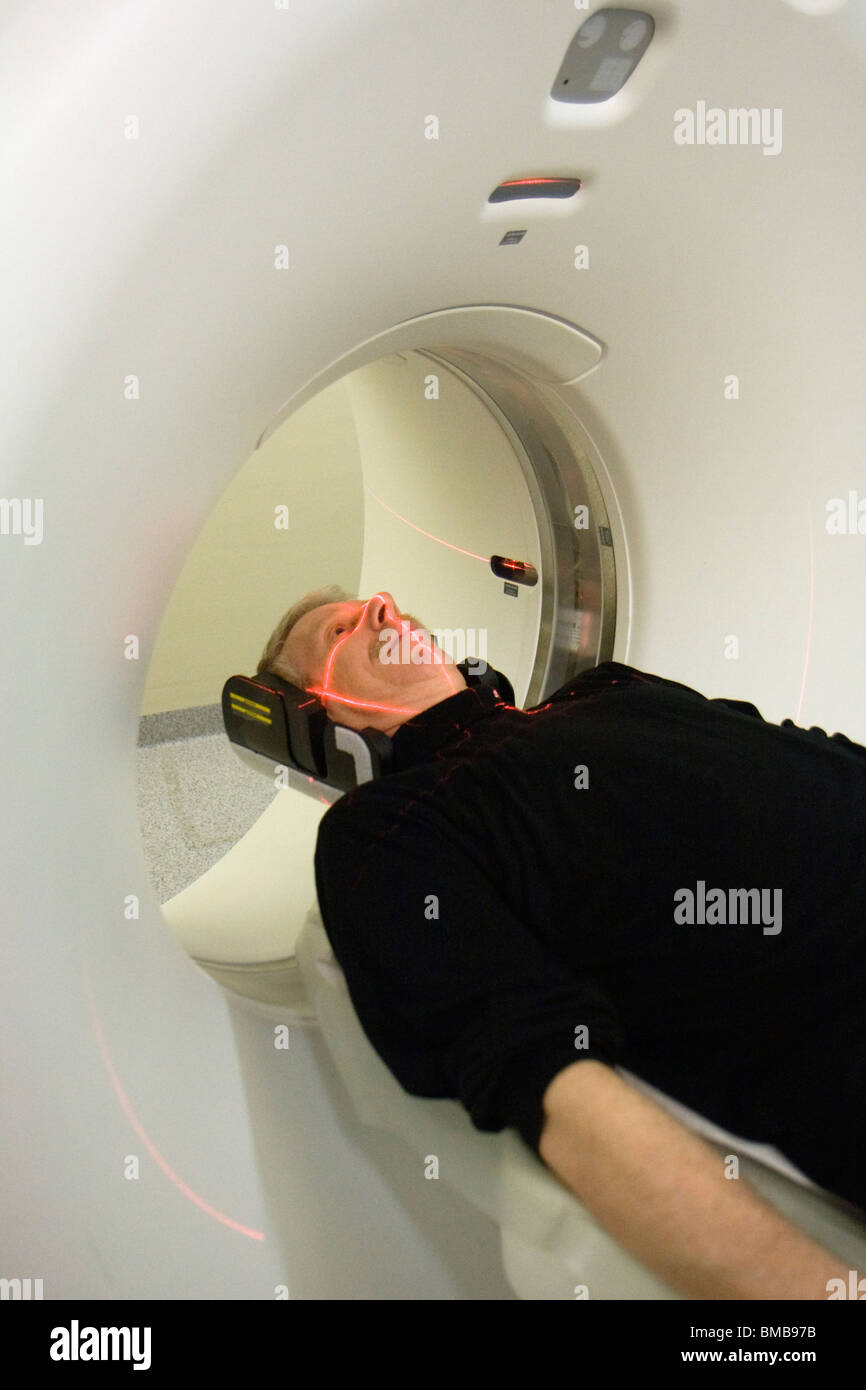 Man being adjusted to the right position before doing a CT (Computer Tomography) scan of the head. Stock Photo