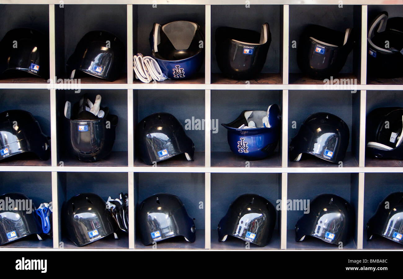 MLB Major League Mets baseball helmets and gloves in rack in the mets dugout at Citi Field Park stadium in New York. Stock Photo