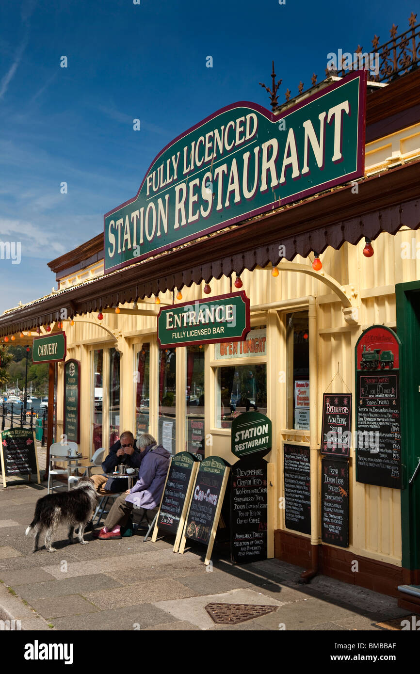 UK, England, Devon, Dartmouth, customers sat in sunshine outside seafront Station Restaurant Stock Photo