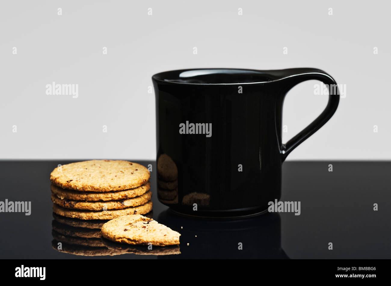 Black Mug and Biscuits Stock Photo