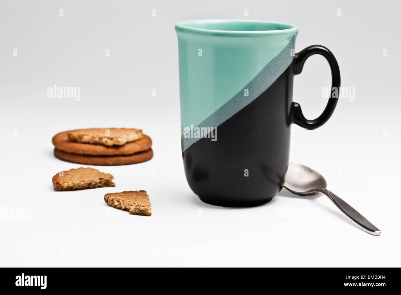 Green/black mug and biscuits Stock Photo