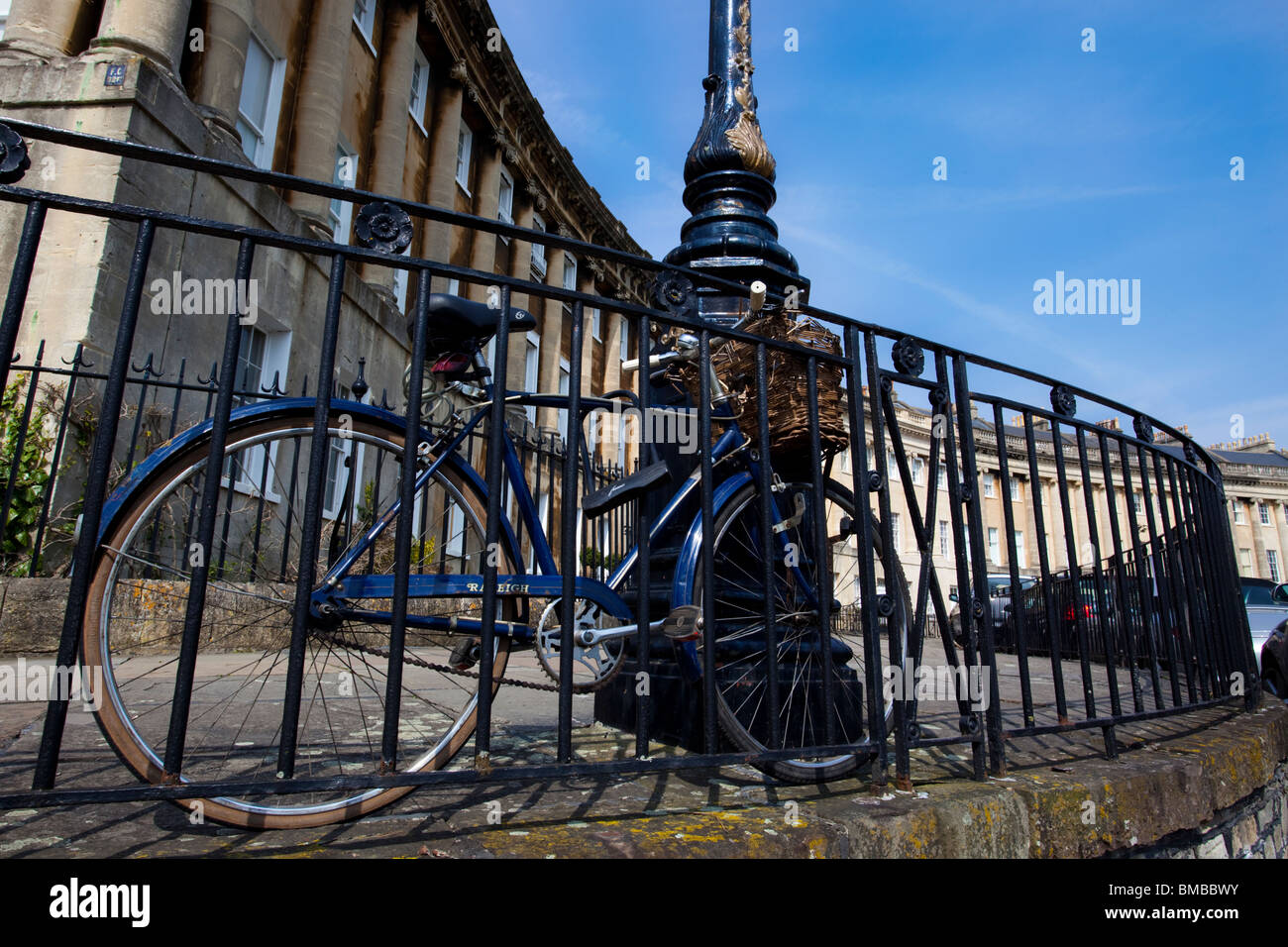 A bicycle chained to rails in The Royal Crescent, Bath, England, UK Stock Photo