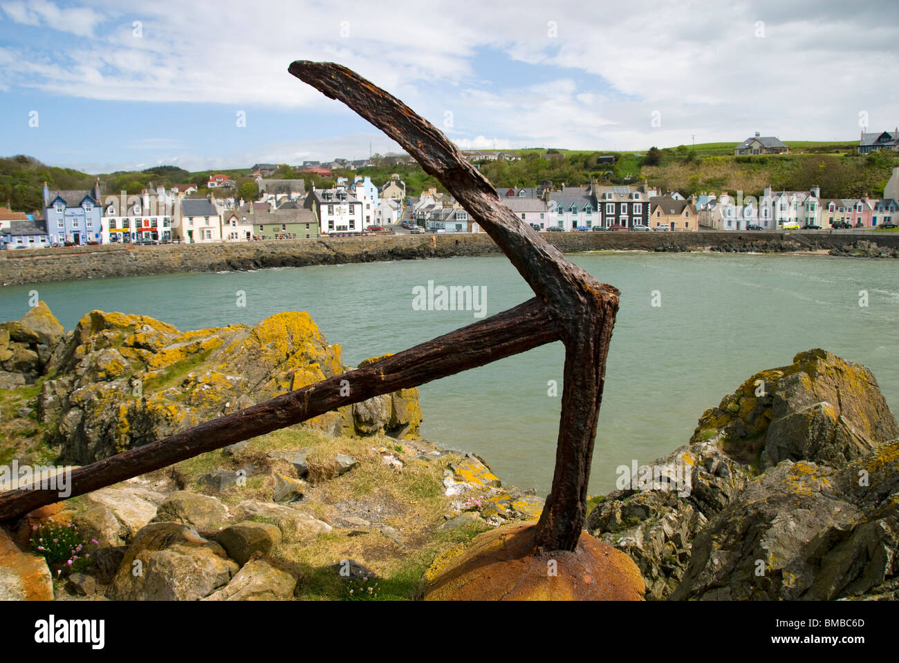 Old rusting anchor set in rocks at Portpatrick harbour, Dumfries and ...