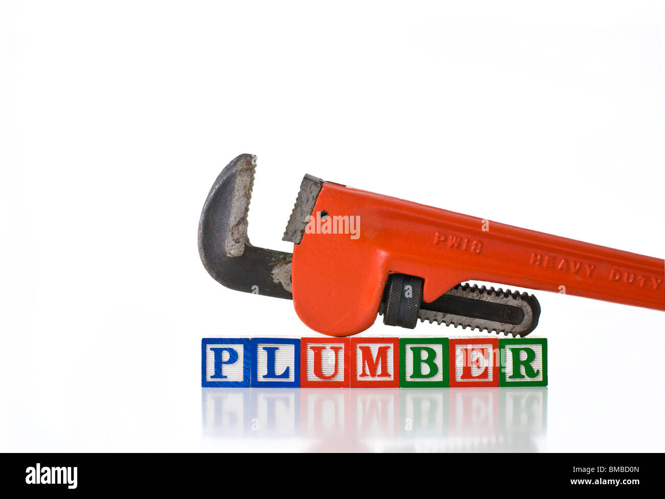 Colorful children's blocks spelling PLUMBER with a pipe wrench Stock Photo