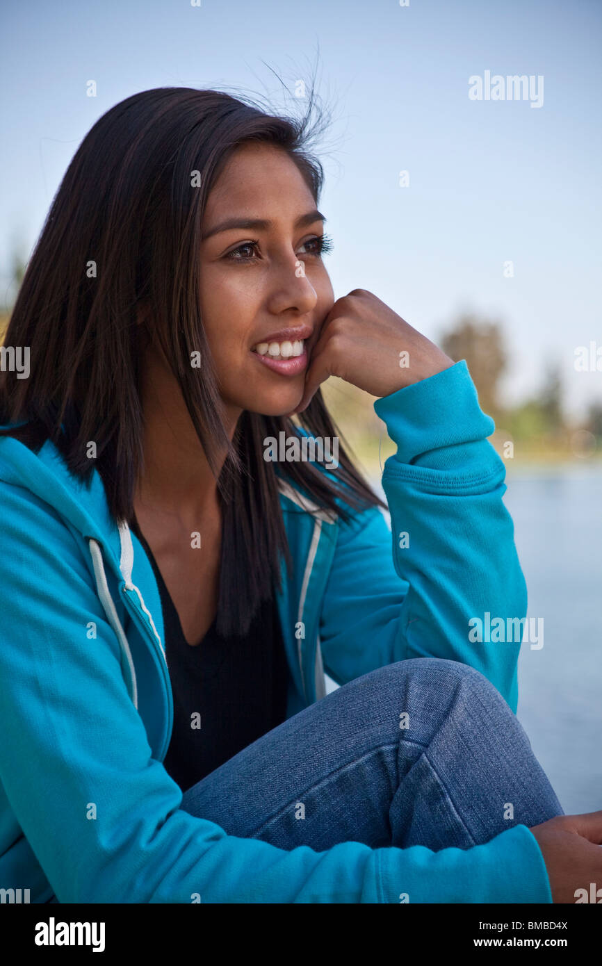 multi ethnic multi racial diversity racially diverse multicultural multi cultural 16 year old girl.thoughtful dreaming sitting profile side view  MR Stock Photo