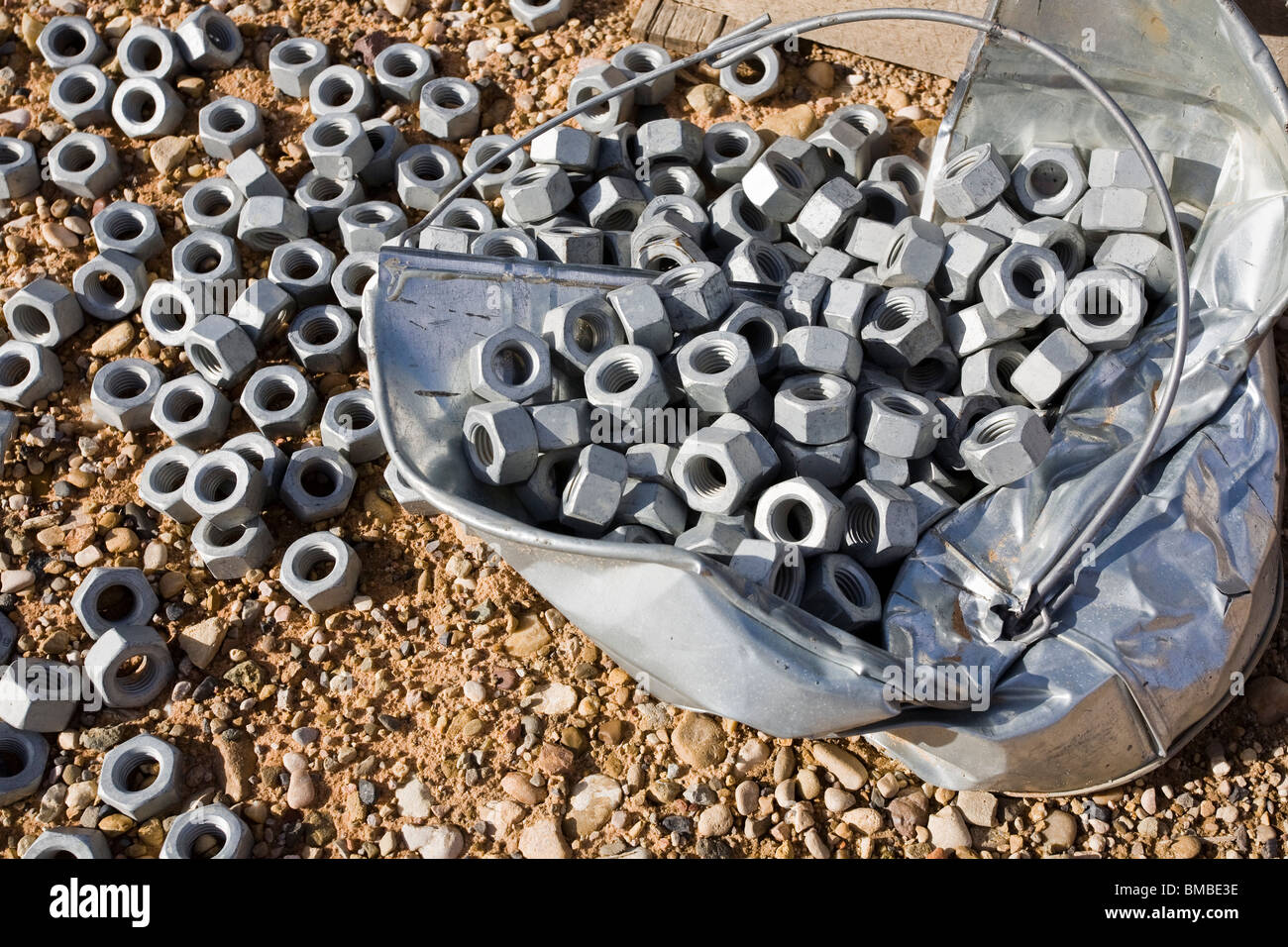 Bucket of heavy duty bolt nuts Stock Photo Alamy