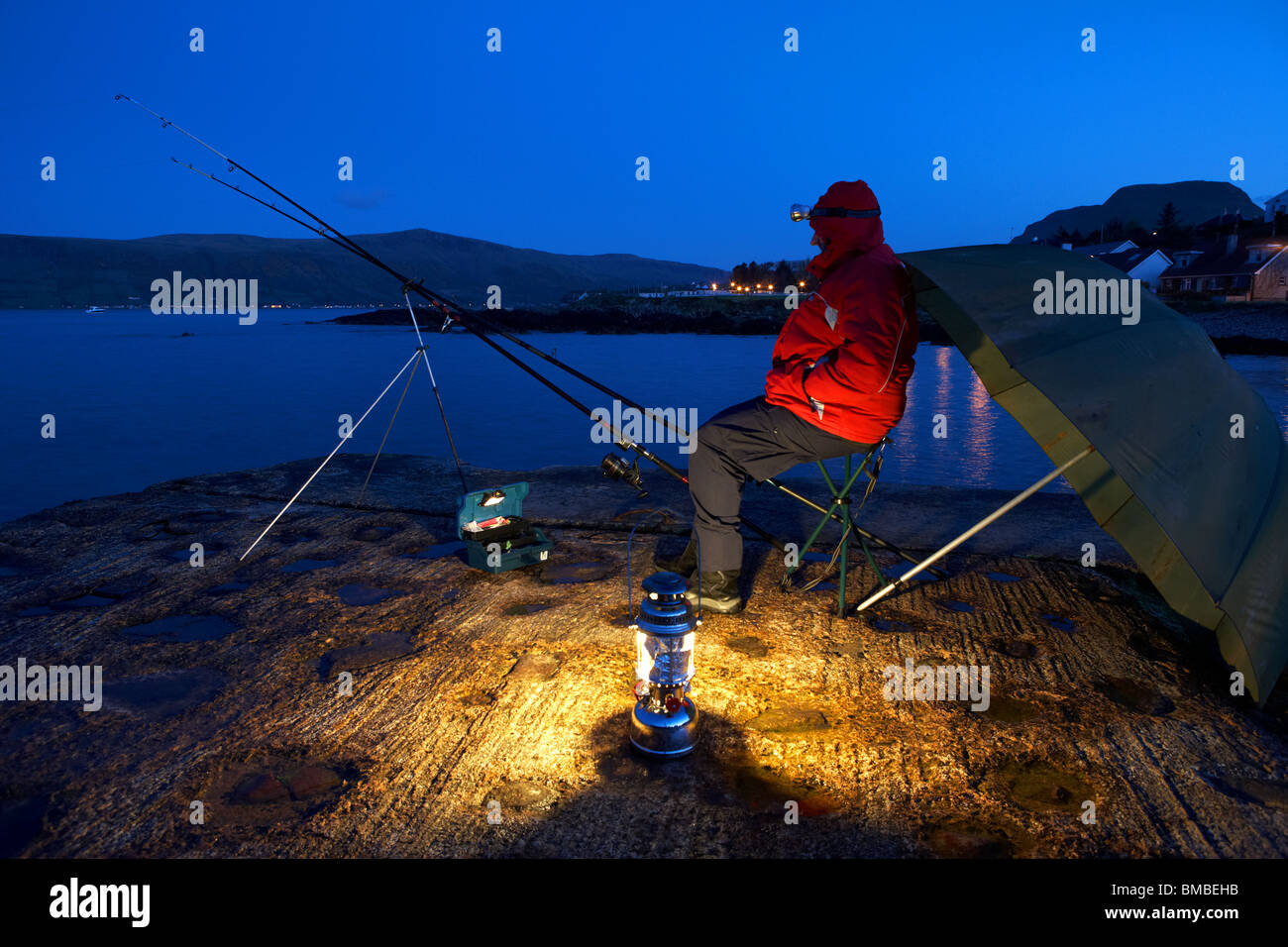 Man Nighttime Fishing On The County Antrim Coast Northern Ireland Uk Stock Photo Alamy