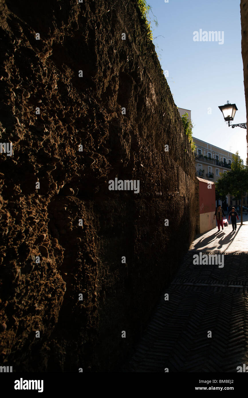 People walking by the medieval city walls, Seville, Spain Stock Photo