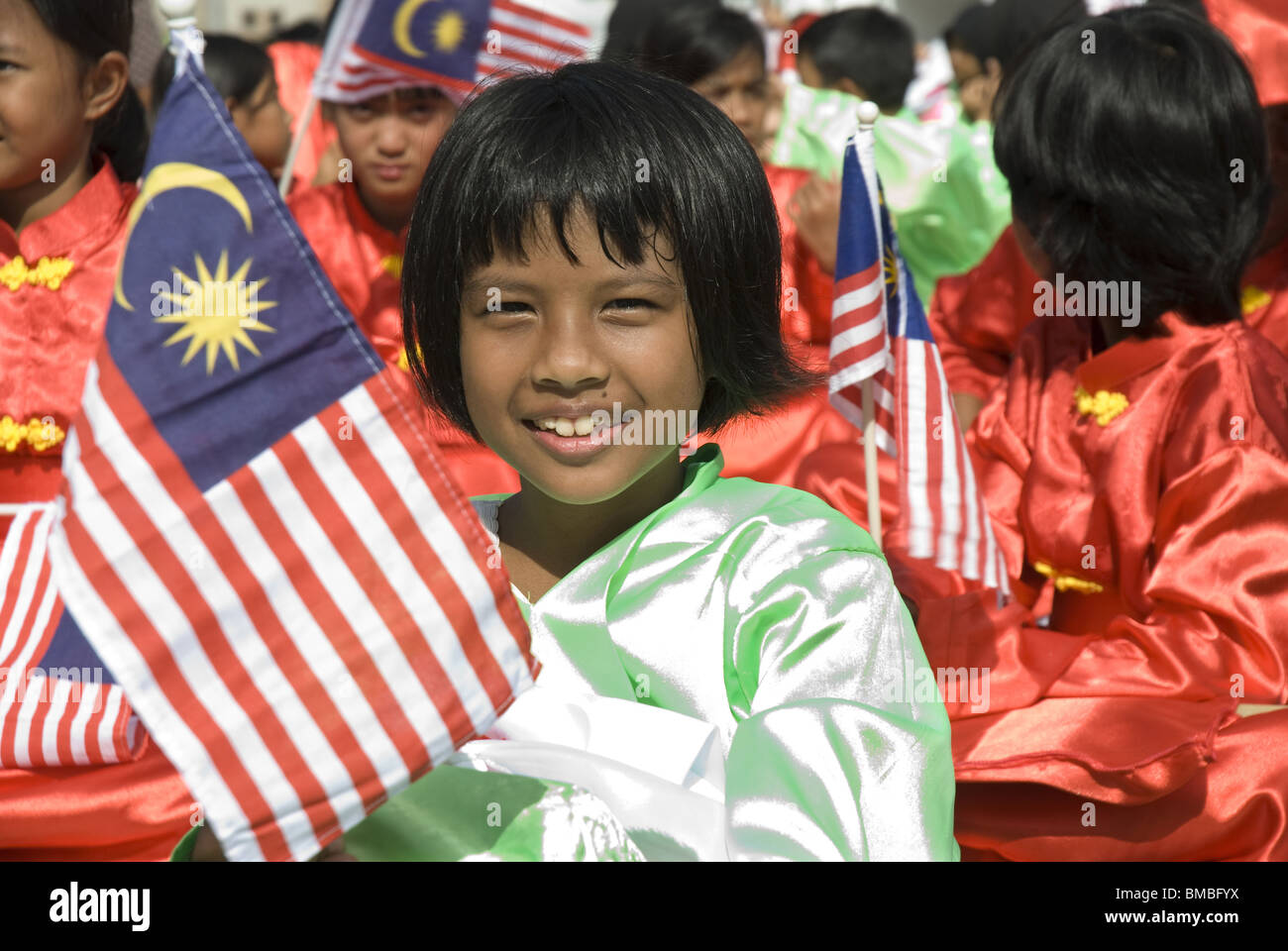 A smiling young performer carrying the Malaysian flag, Merdeka Square, Kuala Lumpur, Malaysia Stock Photo