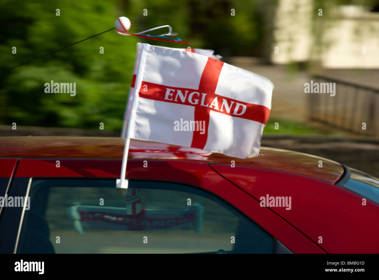 St George's Cross flying out of a Vehicle window Stock Photo