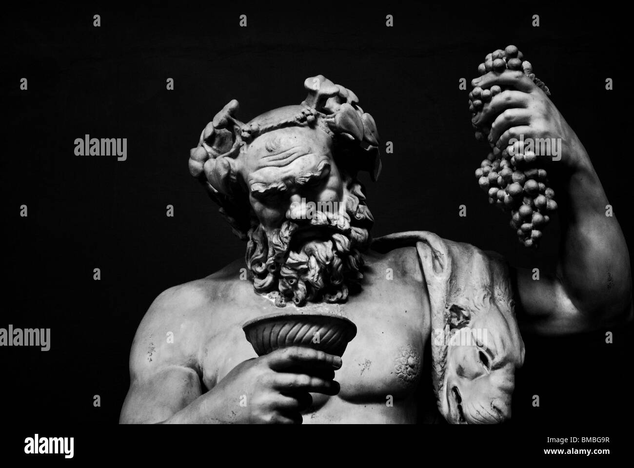 A black and white image of a Greco-Roman statue, depicting God Dionysus/Bacchus at the Vatican museum in Rome Stock Photo