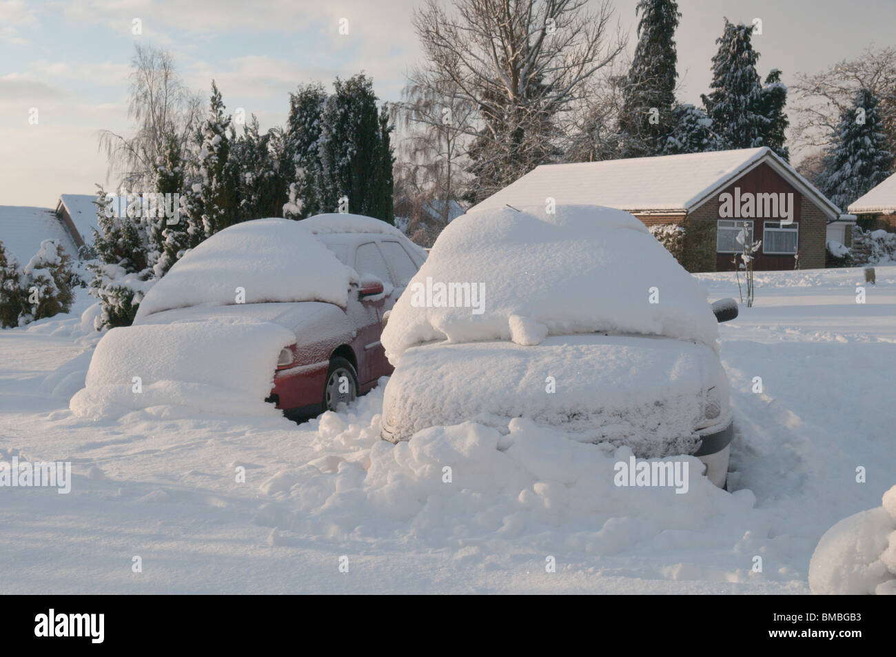 cars parked in a drive covered with snow unable to get out snowbound Sussex Stock Photo